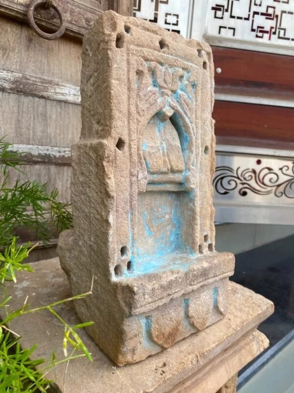 a stone sculpture with blue paint on it