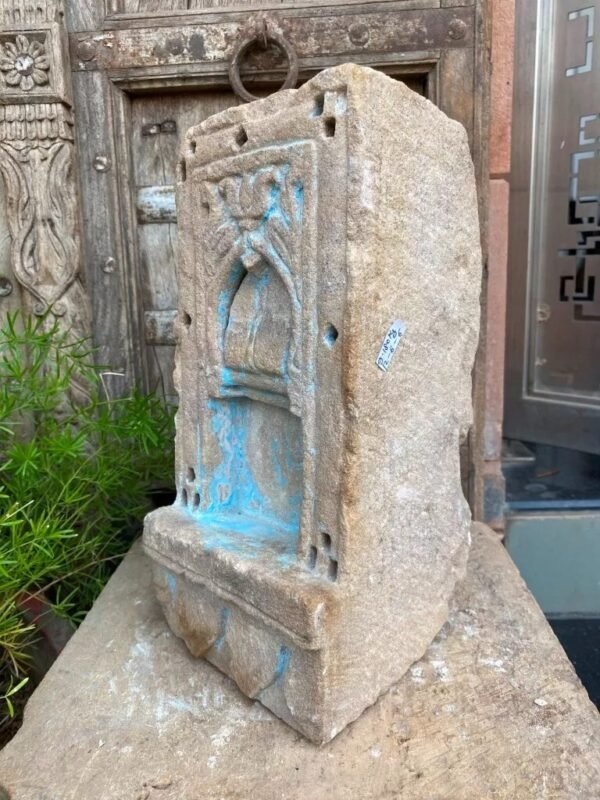 a stone sculpture with blue paint on it