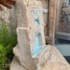 a hand holding a stone sculpture
