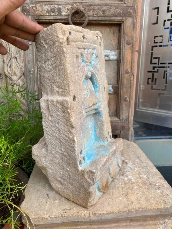 a hand holding a stone sculpture