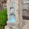 a stone sculpture with blue paint on it