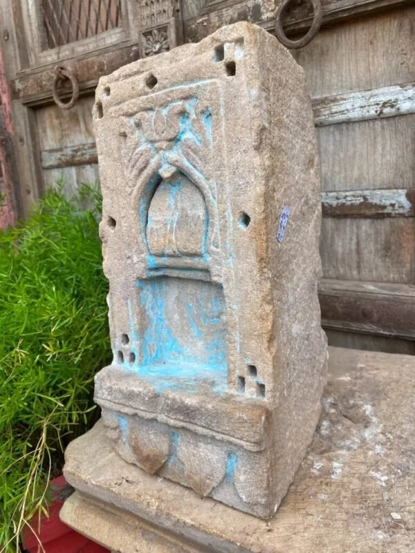 a stone sculpture with blue paint on it