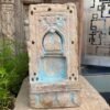 a stone sculpture with blue paint
