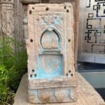 a stone sculpture with blue paint