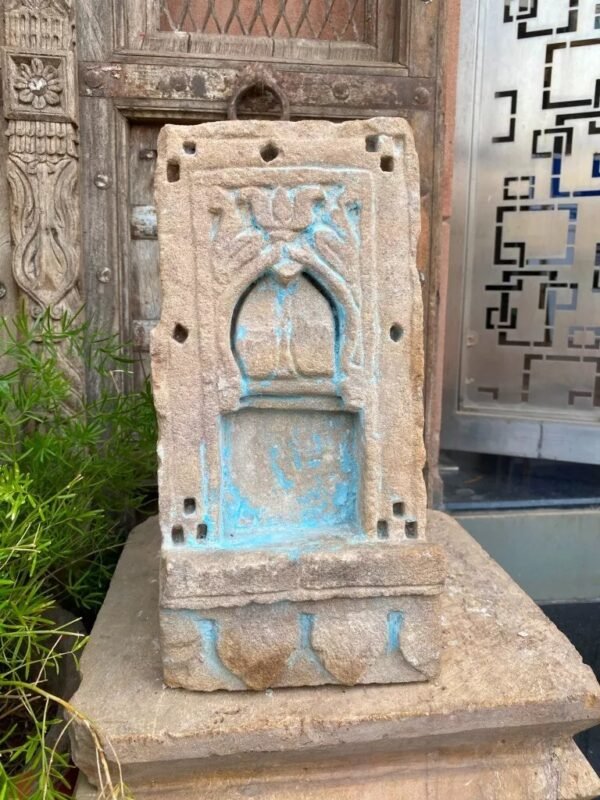 a stone sculpture with blue paint