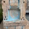 a stone sculpture with blue paint
