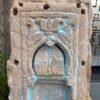 a stone carving of a person with a bird on it