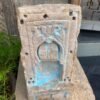 a stone sculpture with blue paint on it