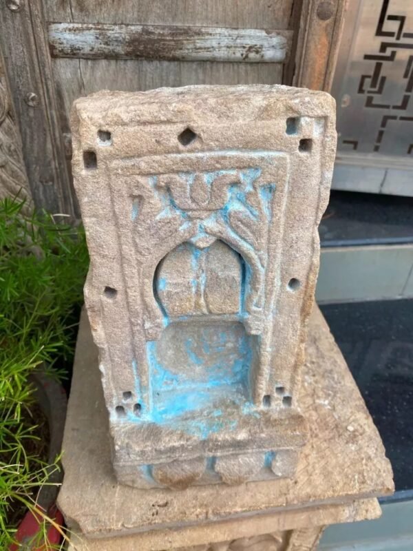 a stone sculpture with blue paint on it