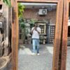 Vintage carved wood floor mirror with floral leaf borders leaning in a living room interior (74 x 43 inches)-collectible vintage